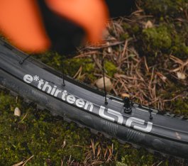 Close-up of an e*thirteen MTB wheel with logo and valve